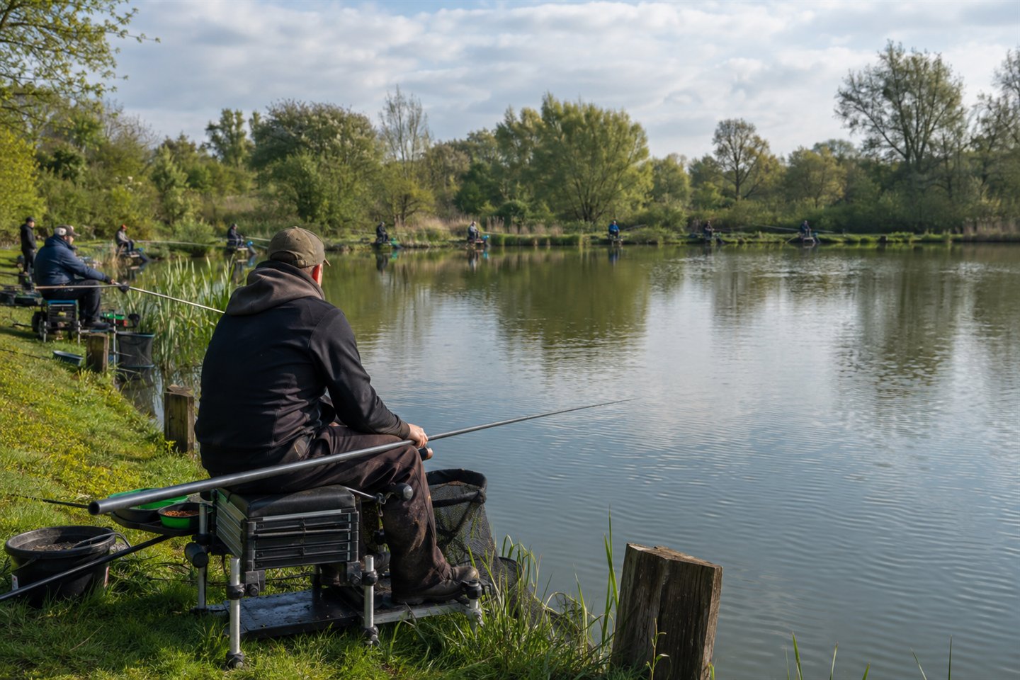 An organised coarse match fishing peg with a seat box, landing net and two simple setups